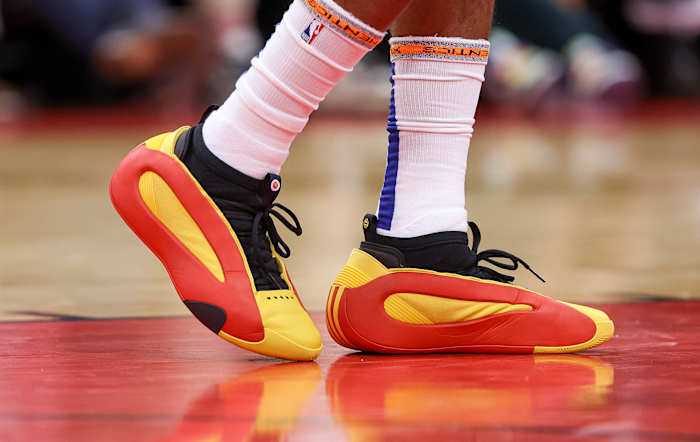  Los Angeles Clippers guard James Harden's red and gold adidas sneakers.